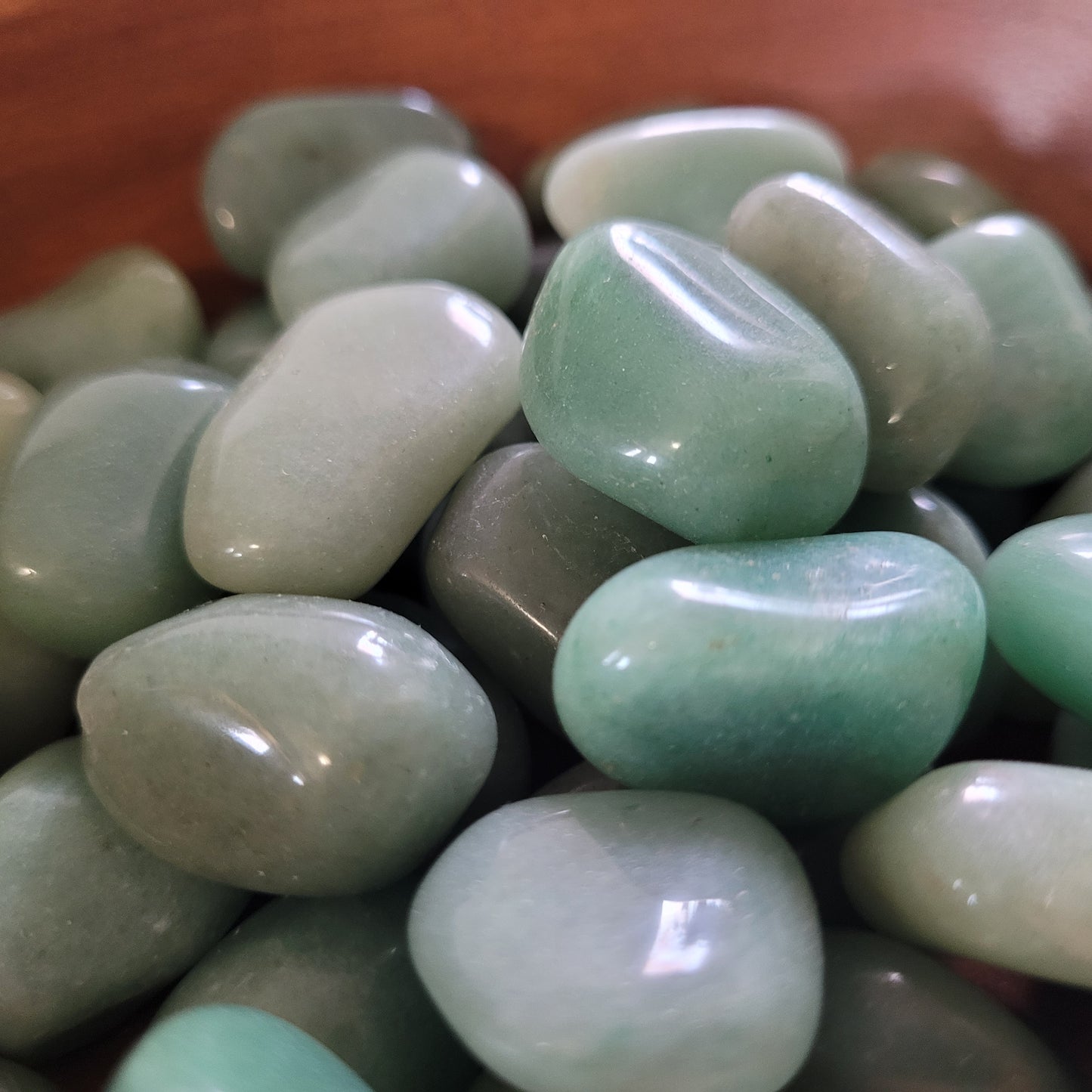 green aventurine tumble in a bowl